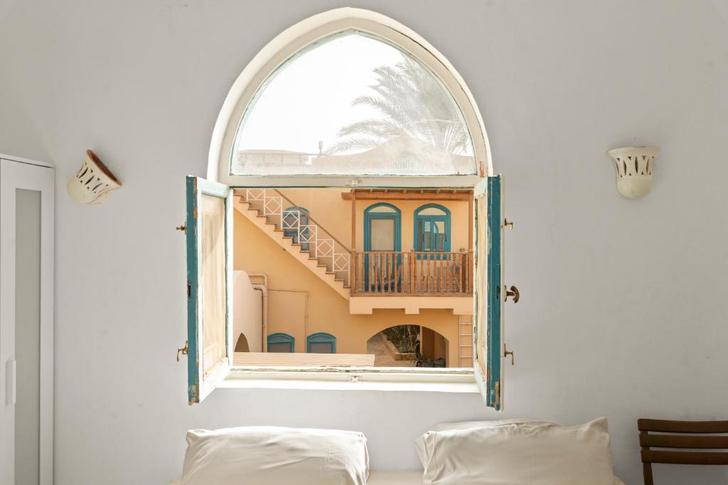 an arched window in a room with a balcony at The Downtown Getaway Studio in Hurghada