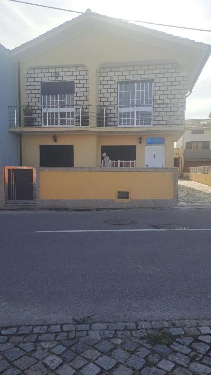 a dog sitting on a balcony of a building at Mar Rosa in Aguçadoura