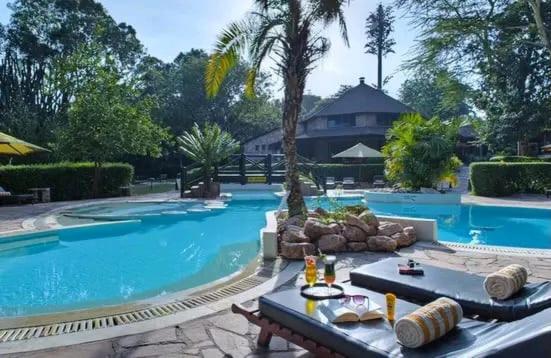 a large swimming pool with a table in front of it at Sekenani,Leparan Lodge in Narok