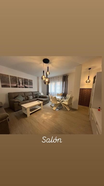 a living room with a couch and a table at Piso Moredas in Dúrcal