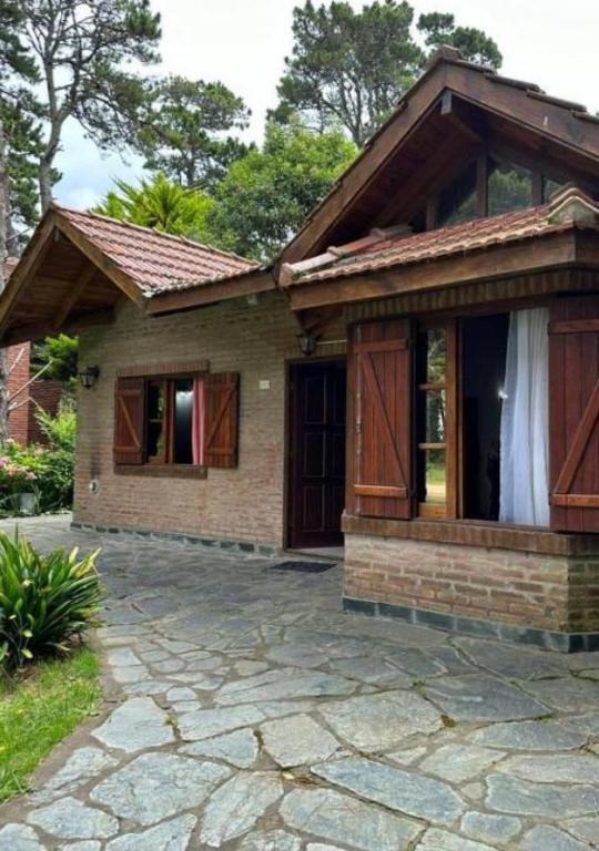a small house with a stone patio in front of it at OKIN 26 Unica in Costa del Este