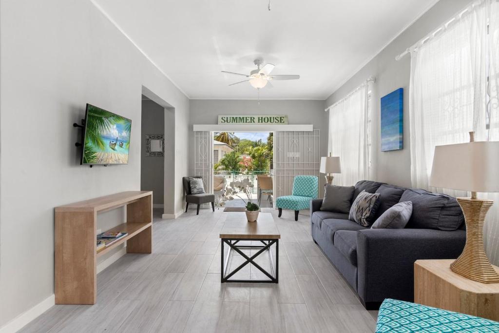 a living room with a couch and a table at Palasette Dover Gardens Barbados in Christ Church