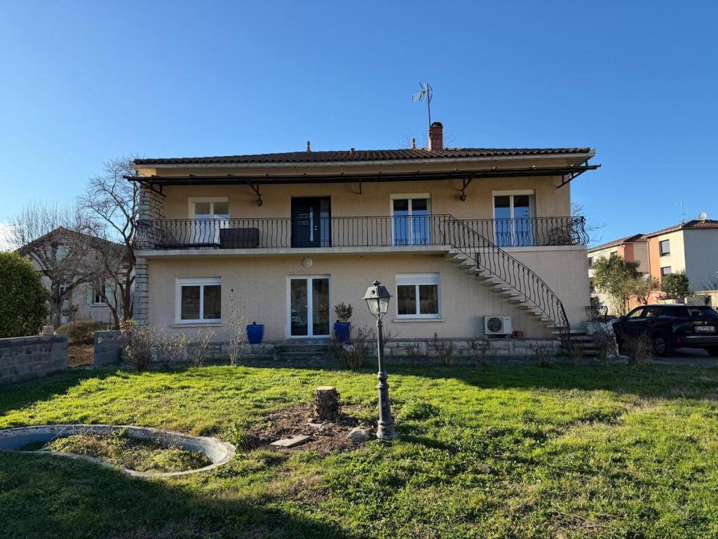 a large house with stairs on top of a yard at Nid Garona in Carbonne