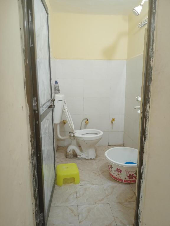 a bathroom with a toilet and a tub at Abhinav Home stay in Ayodhya