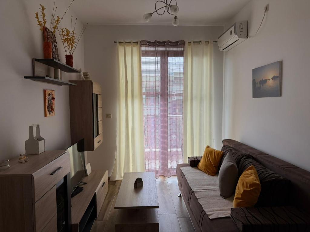 a living room with a couch and a large window at Modern Apartment with Balcony in Przno - Near Beach in Pržno