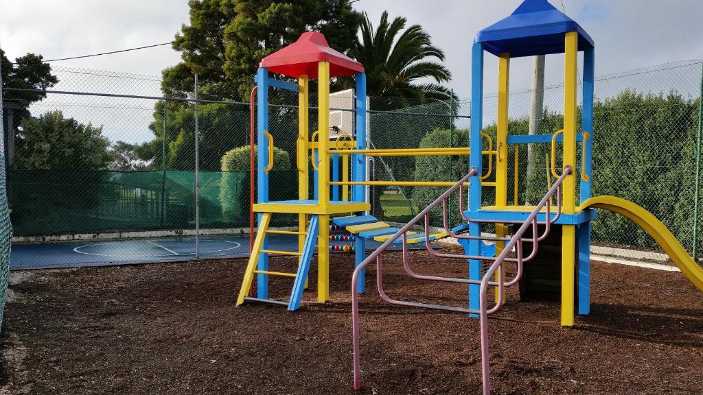 a playground with a colorful play equipment at Shearwater Resort in Port Sorell