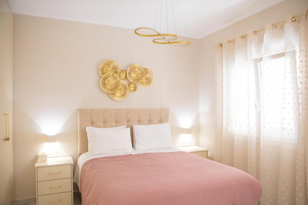 a bedroom with a pink bed and a window at Luxury and Cozy Chios in Chios