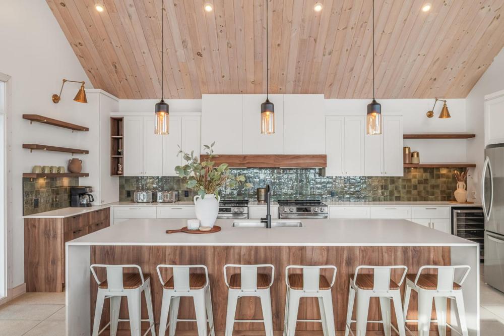 a kitchen with a kitchen island with bar stools at 32 Chemin Blanc in Stoneham