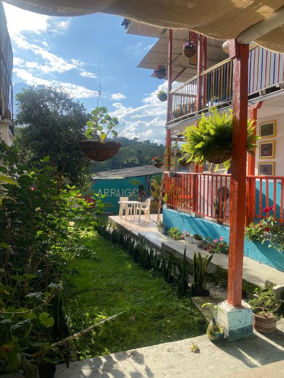 a balcony of a house with plants on it at Hostal Arraigo - A 1 calle del Parque Principal in Santa Rosa de Cabal
