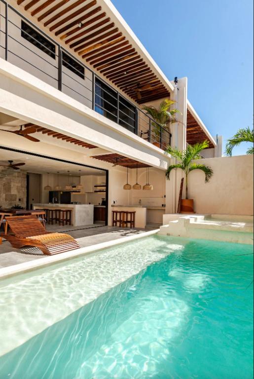 a large swimming pool in front of a house at La Barra Resorts Luxury Villas in Paso Hondo