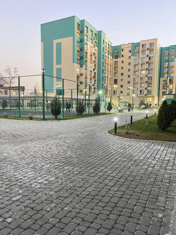 a brick courtyard in front of a large building at ЖК City plus Евродвушка in Almaty