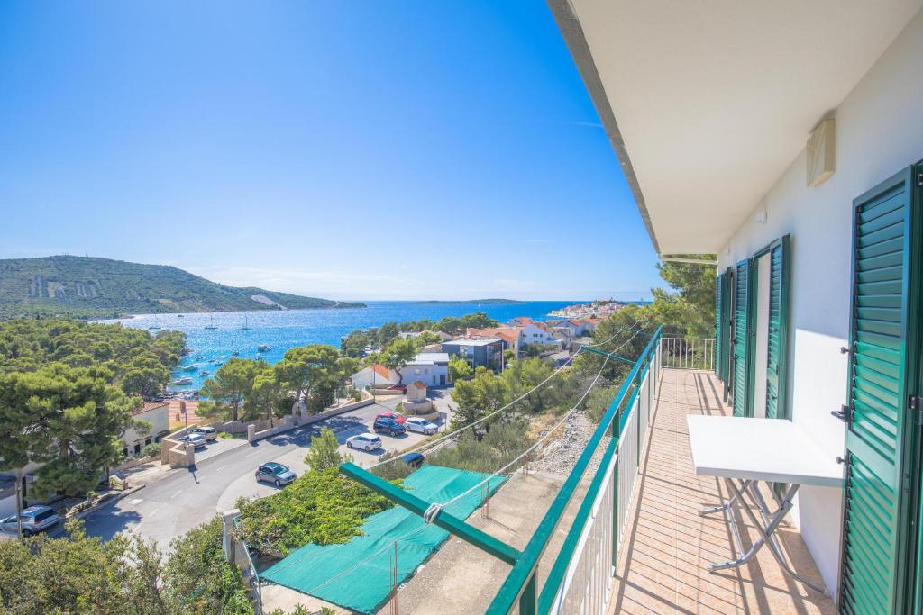 a balcony with a view of the ocean at Apartmani Jurin in Primošten