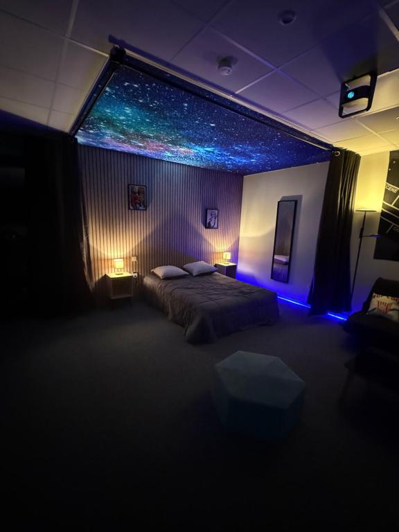 a bedroom with a bed and a window with lights at Studio La Bobine in Coincy