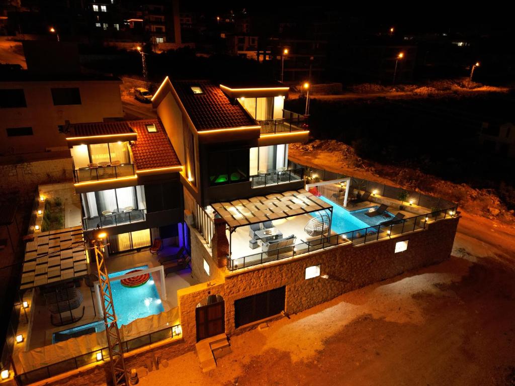 an aerial view of a house at night with a swimming pool at Villa Belmora Villa Asgora in Demre