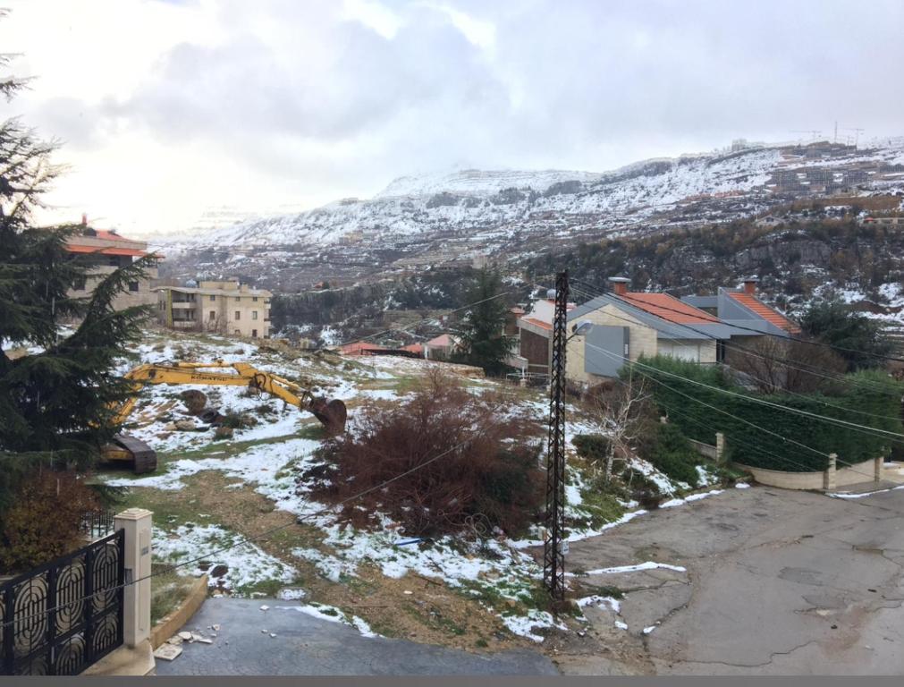 a view of a town with a snow covered mountain at Cozy appartment in hrajel in Dir‘alī