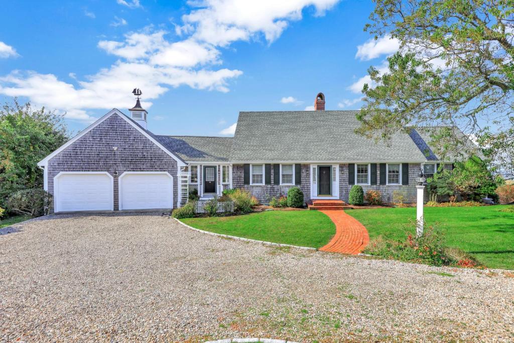 a house with a driveway and a garage at Oceanaire in Dennis