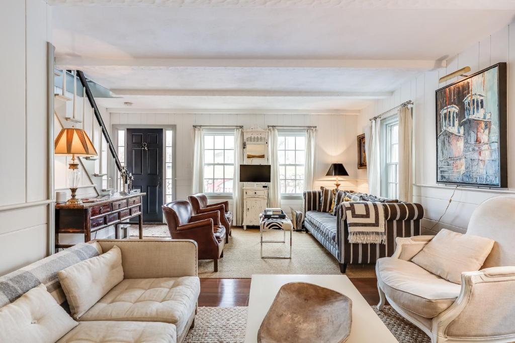 a living room with couches and chairs at The Cook House in Provincetown