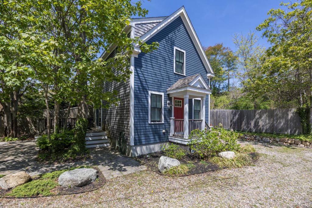 a blue house with a red door at Cod Hollow in Provincetown