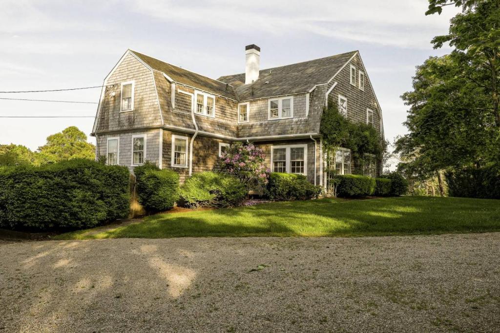 an old house with a gravel driveway at Aweigh We Go in Chatham