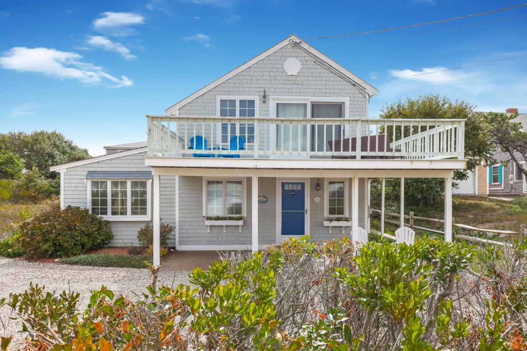 a house with a large deck on a beach at Bayside Bliss in Dennis