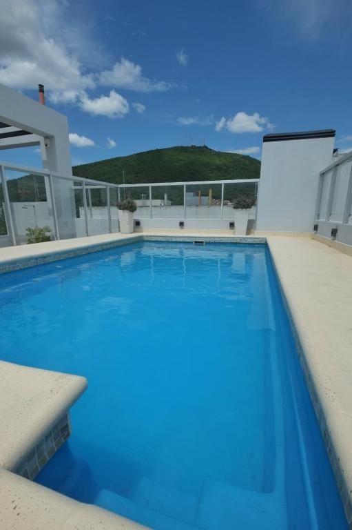 a large swimming pool on the roof of a house at Legui Suites in Salta