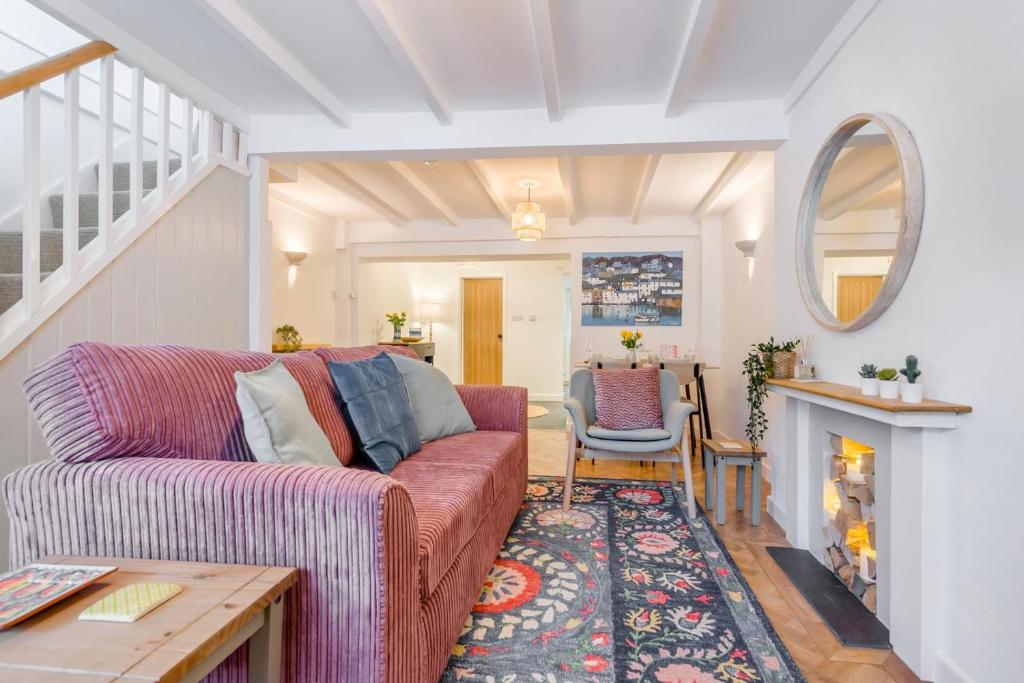 a living room with a couch and a fireplace at 2 Bed in Wadebridge oc-m32567 in Wadebridge