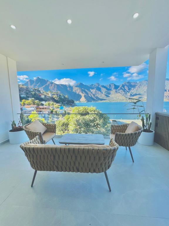 a room with a table and chairs and a view of the ocean at TEL AVIV - Apartamentos by Luxury Atitlan in San Pedro La Laguna