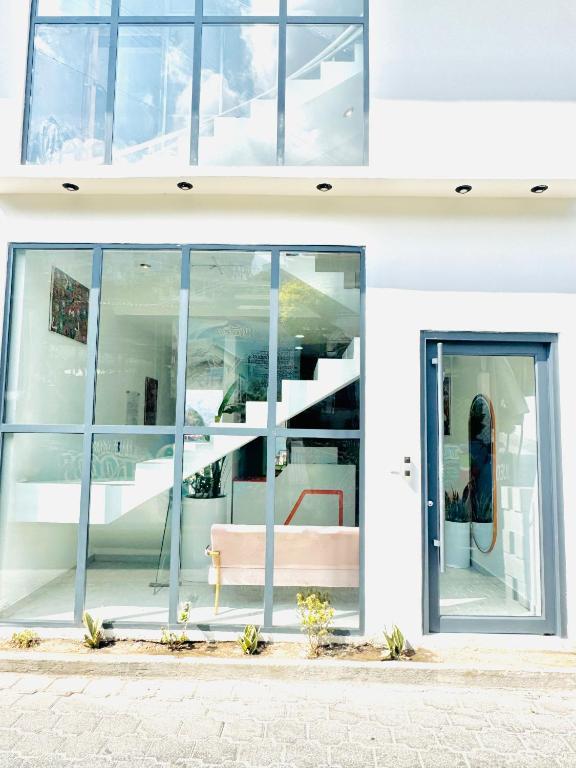 a building with glass doors and a staircase at KOH SAMUI - Apartamentos by Luxury Atitlan in San Pedro La Laguna
