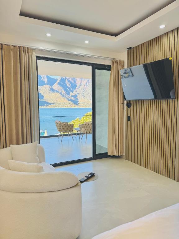 a living room with a couch and a large window at TOKIO - Apartamentos by Luxury Atitlan in San Pedro La Laguna