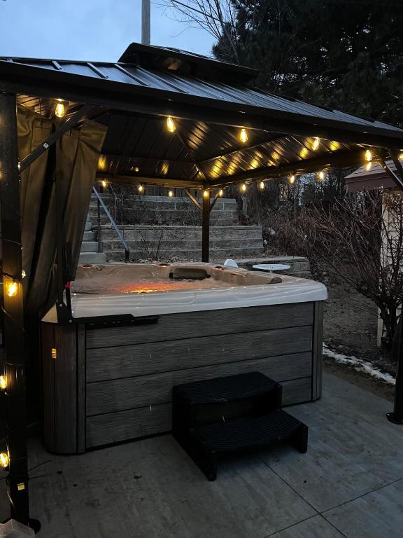 a hot tub under a roof with lights at Casa Lentini in Omaha