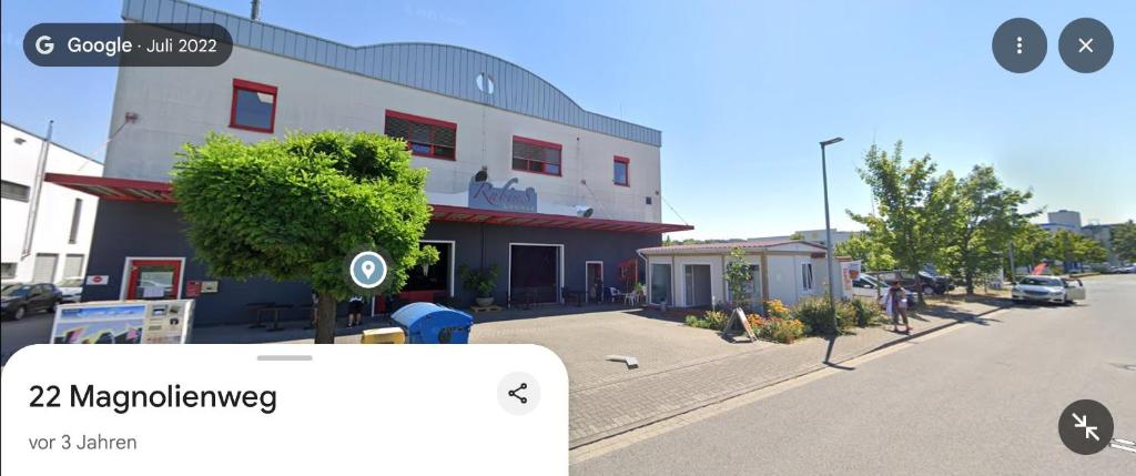a view of a building on a street with a phone screenshot at 1 bedroom apartment 2 guests in Aschaffenburg