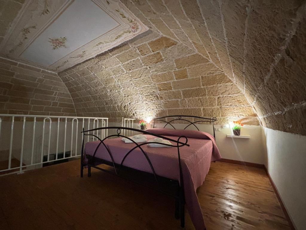 a bedroom with a bed in a brick wall at Casa Vacanze Zia Concetta in Nardò