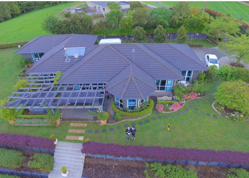 an aerial view of a house with solar panels on it at Waitomo Orchard Estate B&B in Otorohanga