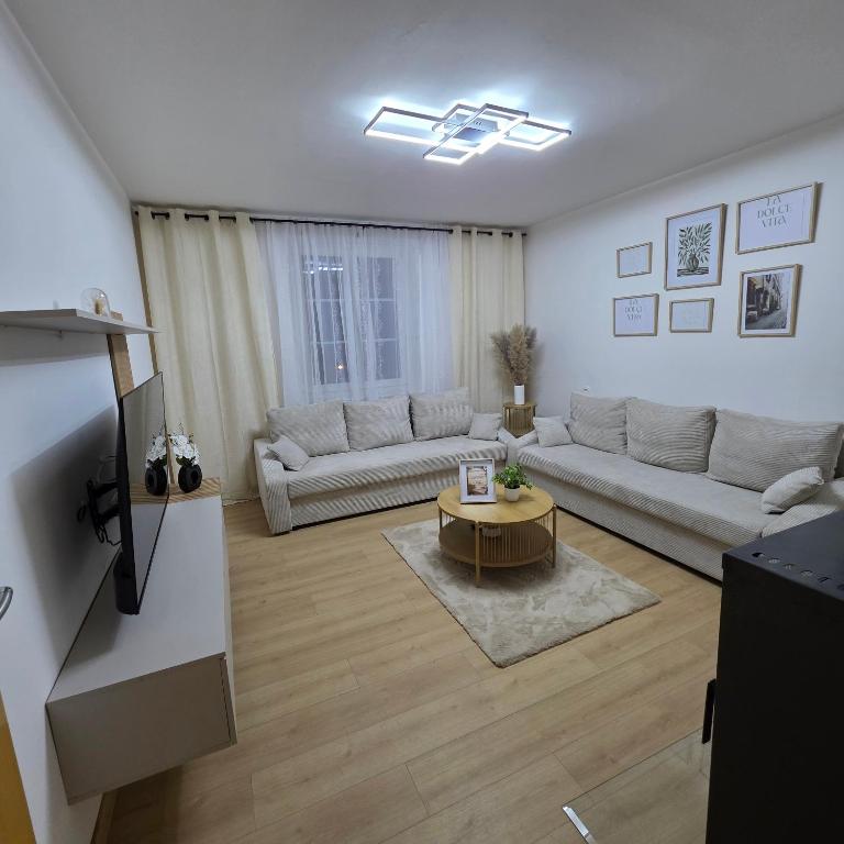 a living room with a couch and a table at Apartment AlpenHerz Trieben in Trieben