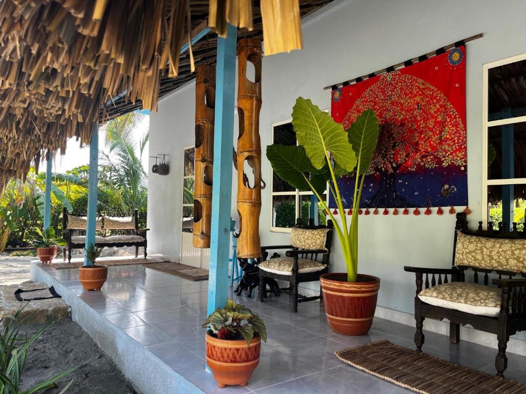 ein Restaurant mit Stühlen und einem Gemälde an der Wand in der Unterkunft Zéfiro Hostal in San Bernardo del Viento