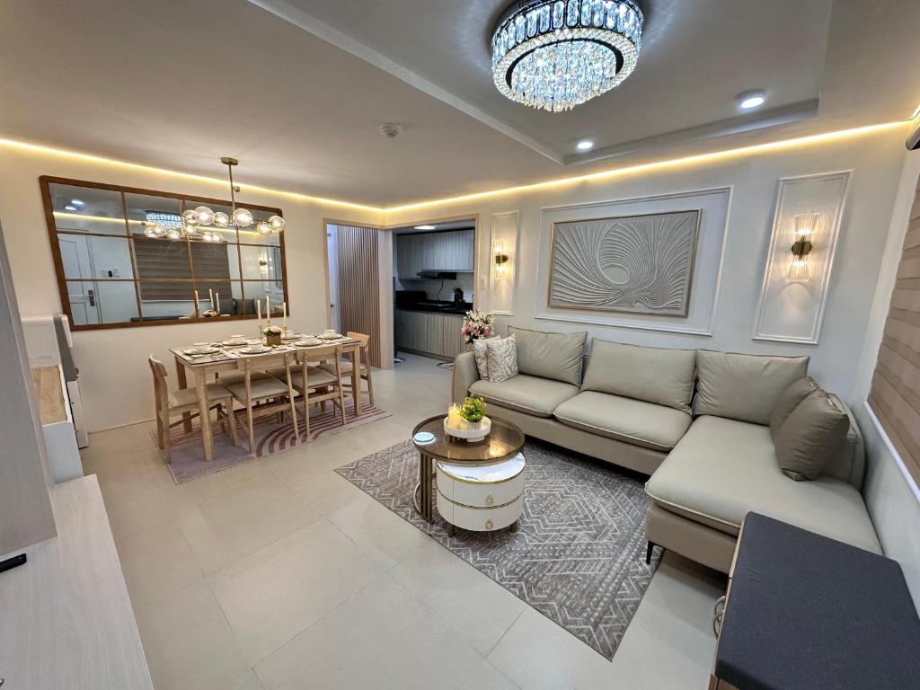a living room with a couch and a table at CJ Premier Stays at Amalfi Oasis Near SM Seaside Mall & Nustar Casino Hotel, Cebu City in Cebu City