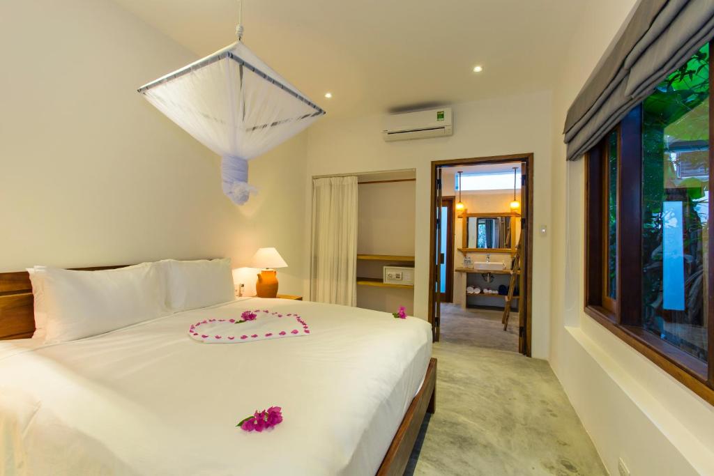 Postel nebo postele na pokoji v ubytování Vina Beach Pool Villas