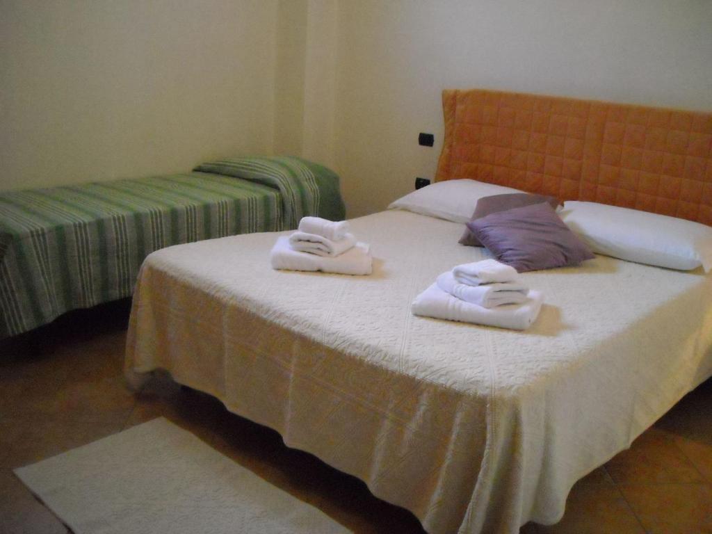a bedroom with a bed with two towels on it at Apartment Manna Hof by Interhome in Irgoli