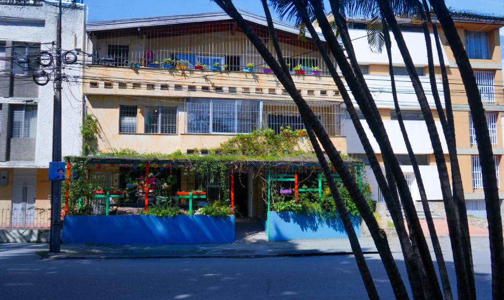 a building with plants in front of a building at Hostal Paz y Vida in Medellín