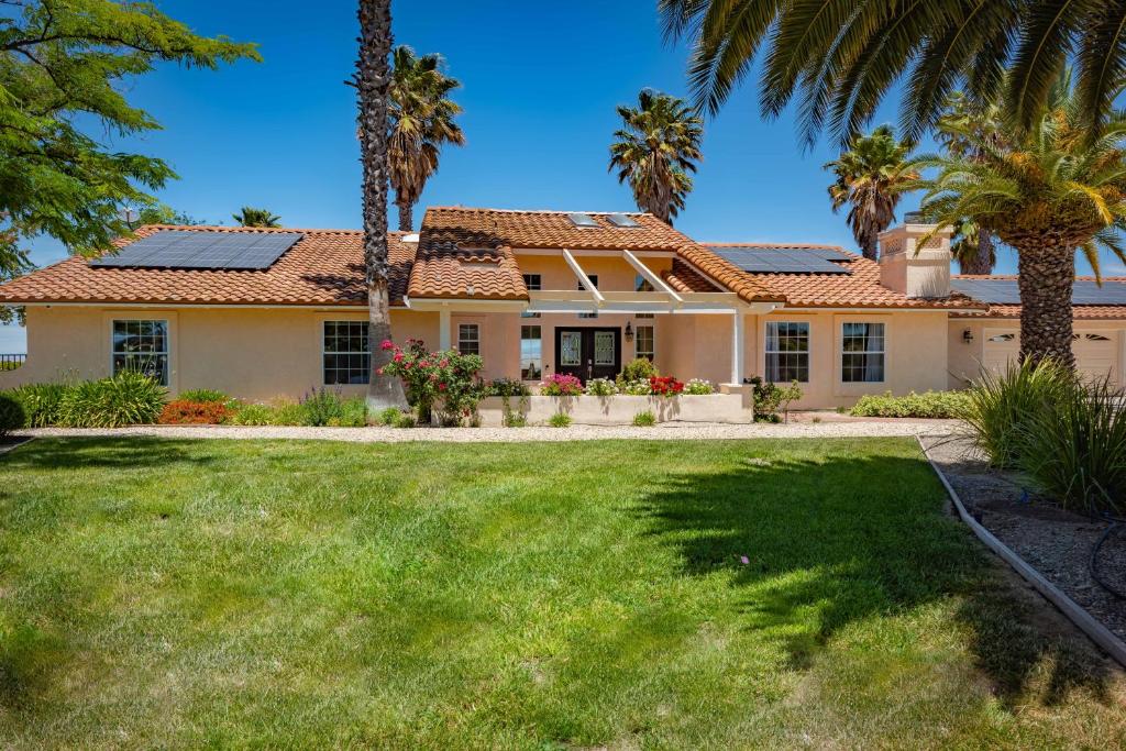 a house with palm trees and a yard at Hilltop Oasis in Templeton