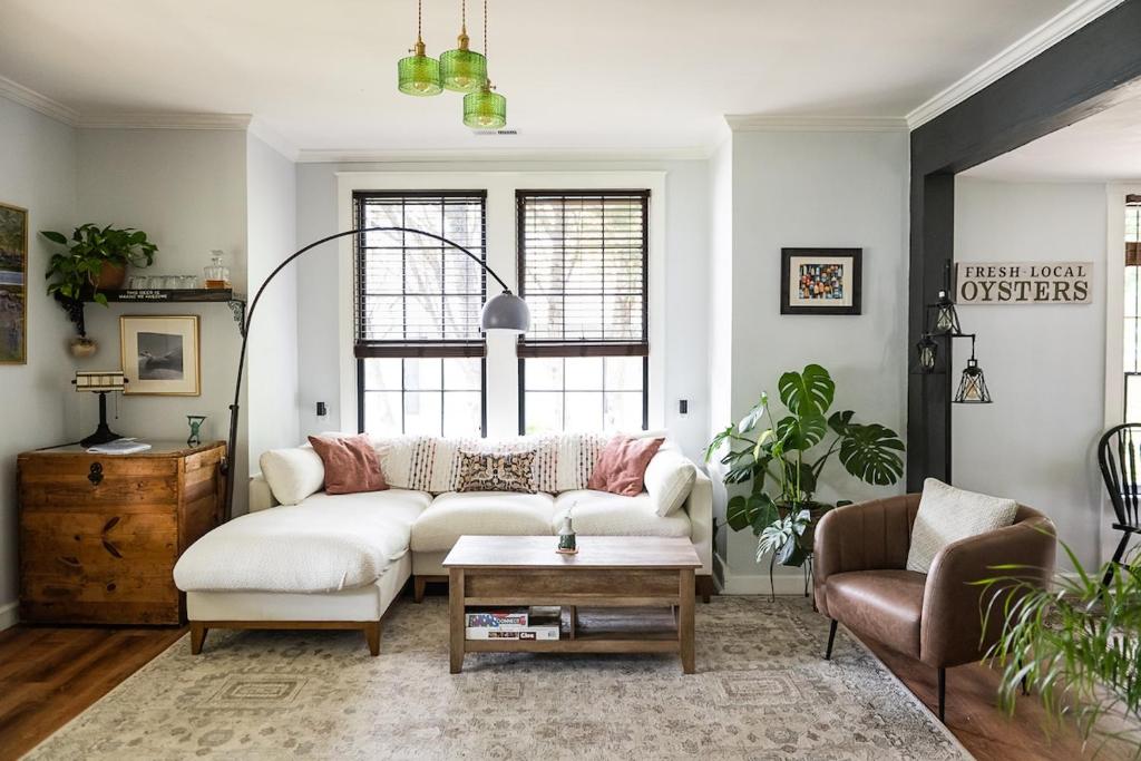 a living room with a white couch and a table at Couples Cottage with Hot Tub in Mathews