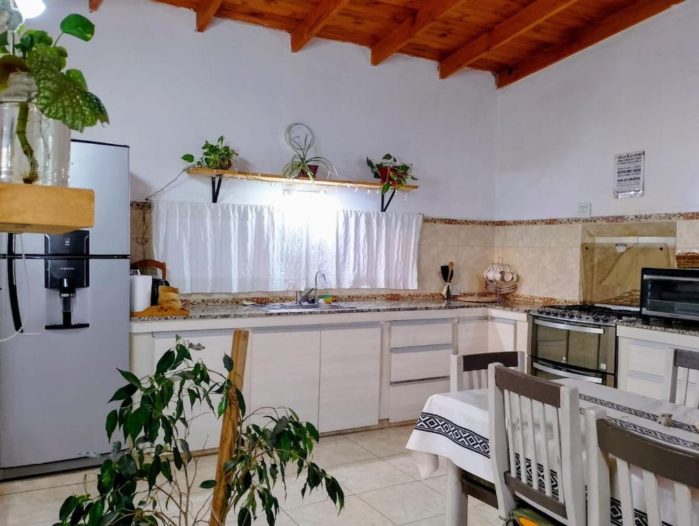 a kitchen with a sink and a stove top oven at Casa de campo in Puerto Madryn