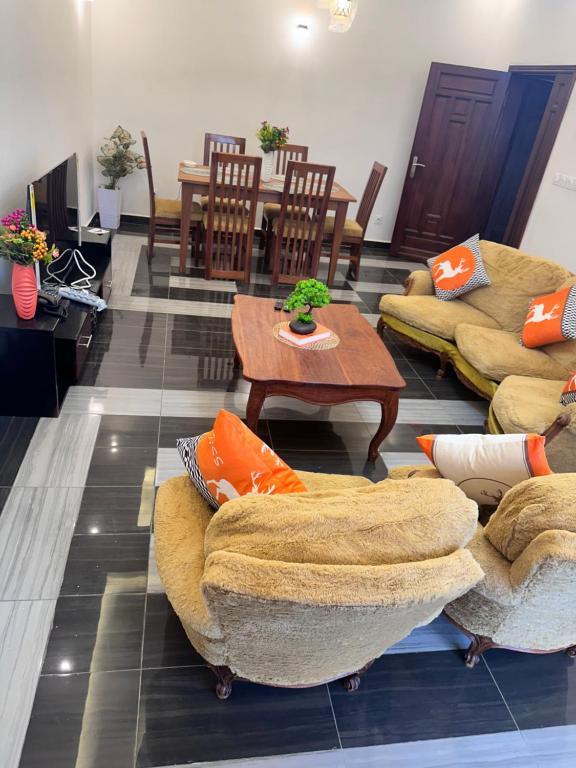 a living room with couches and a table at Résidence Prestige KGV Appt 303 in Douala
