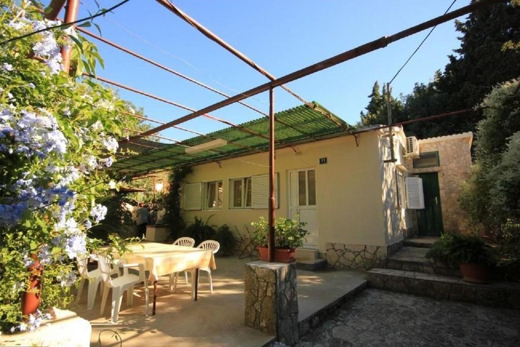 a patio with a table and chairs in front of a house at House Paulo3 in Rogačić