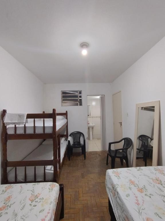a bedroom with two bunk beds and a mirror at Centro de Convenções - Hospedagem in Recife