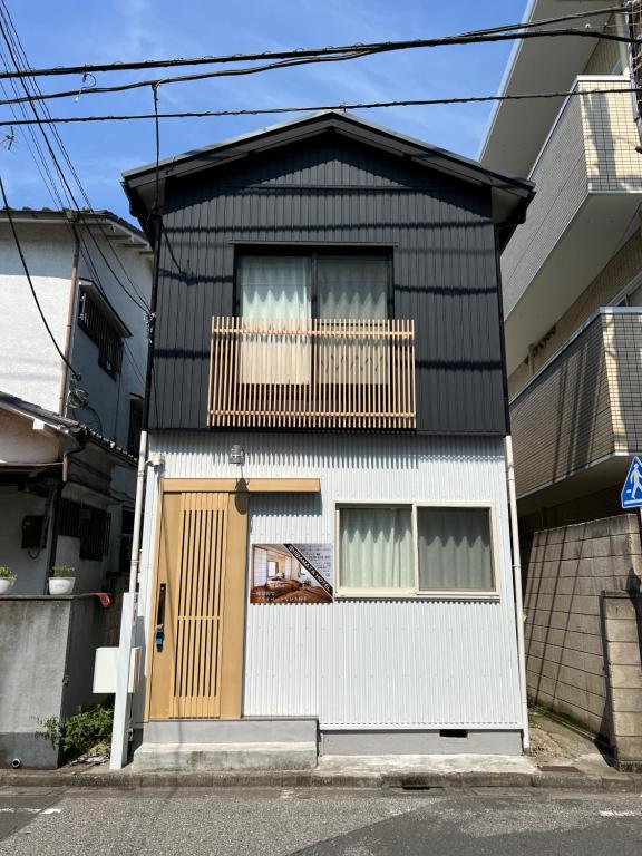 a black and white house with a balcony at WAMARE Shibamata, Entire private two-story house, Traditional Tokyo Stay with Easy Access to Haneda & Narita Airports, up to 4pax in Tokyo