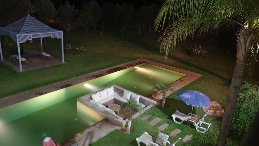 an overhead view of a swimming pool at night at Villa Maloulou in Marrakesh