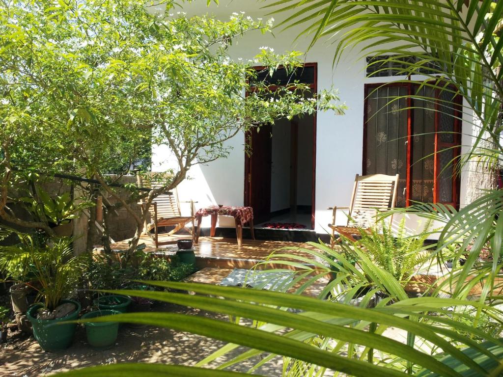 a garden in front of a house with plants at Green Garden Guest Mirissa in Mirissa