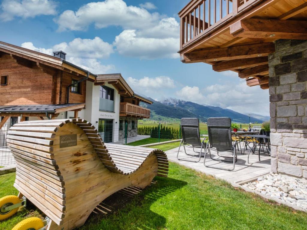 a wooden rocking horse in the yard of a house at BergbiberHAUS XL in Piesendorf