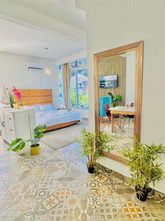 a bedroom with a mirror and a bed and a table at TIBERIAS by luxury Atitlan in San Pedro La Laguna